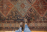 Antique Kamseh carpet with triple medallions, geometric forms, and soft, time-worn colors.