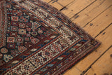 Antique Kamseh carpet corner, showing geometric field motifs and a detailed ivory border.