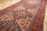 Close-up of Vintage Bibikabad rug's intricate Herati pattern in brick red, navy, and ivory.
