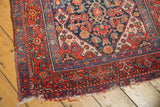 Vintage Bibikabad runner corner with brick red border, navy Herati motifs, and ivory spandrel.