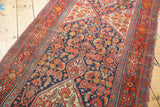Intricate Herati motif with multi-medallion shapes in brick red, navy, ivory, and saffron.