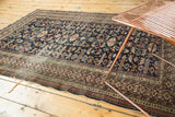 Antique Shirvan rug corner with Kufic border, perepedil design, and tattered edge.