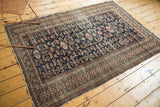 Intricate Kufic border with edge tatter on a hand-knotted antique Shirvan rug.