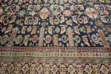Dark blue field with perepedil rams horn motifs and Kufic border on an antique Shirvan rug.
