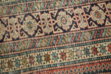 Antique Shirvan rug details: Kufic border, perepedil ram's horn motifs in indigo, red, beige.