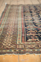 Finely woven geometric Kufic border of an antique Shirvan rug in beige, red, and blue.