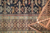 Finely woven antique Shirvan rug detail, classic Kufic border in indigo, red, and beige.