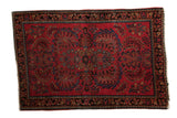 Vintage hand knotted American Sarouk rug, cherry red field, center palmette, and floral vinery.