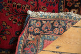 Vintage American Sarouk rug showing intricate floral border, light fringe, and hand-knotted reverse.