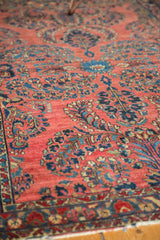 Vintage American Sarouk rug's detailed border, showing cherry red field and blue floral vinery.