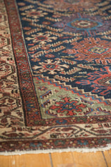Rich indigo geometric weaving contrasting with detailed antique ivory border of vintage Hamadan runner.