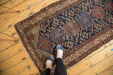 Vintage Hamadan runner showcasing geometric medallions, deep indigo Herati motif, and madder red tones.
