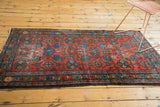 Vintage Lilihan rug, right side with brick red field, blue floral tendrils, and wear.