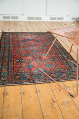 Vintage Persian Lilihan rug's end border with floral motifs in blue, brick red, green, and light tatter.