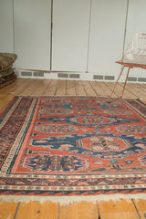 Vintage Caucasian Soumac rug fringe and zig-zag border with red, blue, and blush tones.
