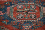 Handwoven Soumac rug detail: octagonal gul motif with red, sky blue, and blush.