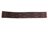 Antique Belouch Soumac rug runner with traditional geometric patterns in dark brick red, charcoal, and ivory.