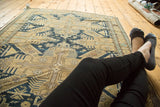 Antique Caucasian rug: intricate geometric field patterns in dark navy, sand, and powder blue.