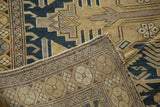 Antique Caucasian rug with hand-knotted back and sand, navy geometric patterns.