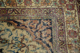 Corner of antique Kermanshah rug, Safavid border with dark ground and intricate floral field.