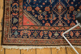 Hand-knotted Engelas rug corner, indigo Herati motif, birds, terra cotta border, fringe.