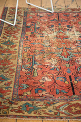 Detail of antique Malayer rug: faded raspberry field, blue rectilinear vinery, wear showing foundation.