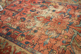Antique Malayer rug detail showing faded raspberry, blue, and green vinery with exposed foundation.