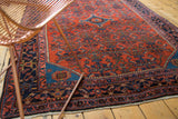 Engelas rug corner with sapphire blue spandrel, ornate navy border, and brick red Herati motif.