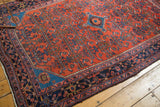 Engelas rug corner with sapphire blue spandrel, brick red Herati field, and navy border.