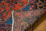 Folded Engelas rug showcasing brick red pile and tightly woven hand-knotted foundation.