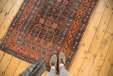 Tattered end and rich floral borders of an antique Kurdish Bijar rug runner.