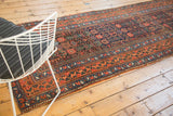 Antique Kurdish Bijar runner end, showcasing geometric orange, navy, and blue border with tatter.