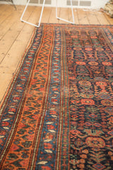 Antique Kurdish Bijar rug detail with geometric orange border and navy field henna plant motif.