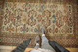 Geometric Kufic border framing red rams horn motifs on an ivory ground Caucasian Perpedil rug.