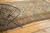 Antique Perpedil rug with ivory ground, madder red Kufic border, and rams horn motifs.