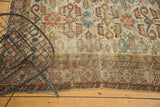 Ivory ground Caucasian Perpedil rug with geometric Kufic border and madder red rams horn motifs.