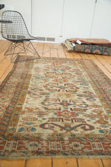 Geometric Kufic border and rams horn design in madder red, sky blue, and ivory on this antique Perpedil rug.