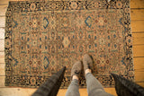 Antique Farahan Sarouk rug featuring curvilinear allover botanical motifs in blush, green, and sky blue.
