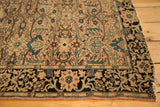 Farahan Sarouk rug corner with detailed navy border, flowing botanical design, and time-softened edge.