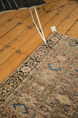 Antique Farahan Sarouk corner with dusty rose field, blue scalloped florals, and navy border.