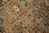 Curvilinear tree of life motif and scalloped florals on dusty rose antique Farahan Sarouk rug.
