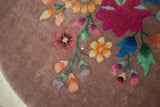 Detail of Nichols Art Deco rug: fuchsia, blue, gold lotus floral design.