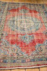 Even wear to knot heads and fringed edge on a distressed Oushak rug.