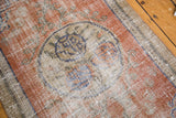 Distressed Oushak rug pile, roundel medallion, faded ruby grapefruit, royal blue, foundation exposed.