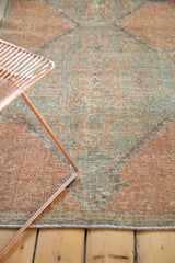 Distressed Oushak rug runner in faded apricot, oxidized silver, and rectilinear patterns.