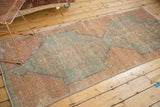 Distressed Oushak runner fragment with primitive apricot and silver rectilinear patterns.