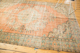 Distressed vintage Oushak rug border, with peach, mint, and antique ivory tones.