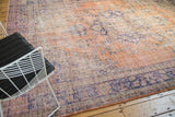 Distressed Oushak carpet texture with faded peach and royal blue tones.