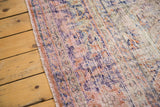 Distressed overdyed Oushak carpet texture with exposed foundation, faded peach and blue.