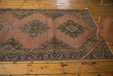 Distressed texture of a Vintage Sparta runner with faded apricot field and alternating medallions.
